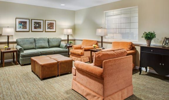 A cozy living room with comfortable seating and warm lighting.
