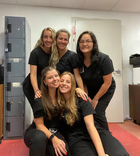 A joyful moment captured with friends in black outfits, showcasing camaraderie and teamwork.