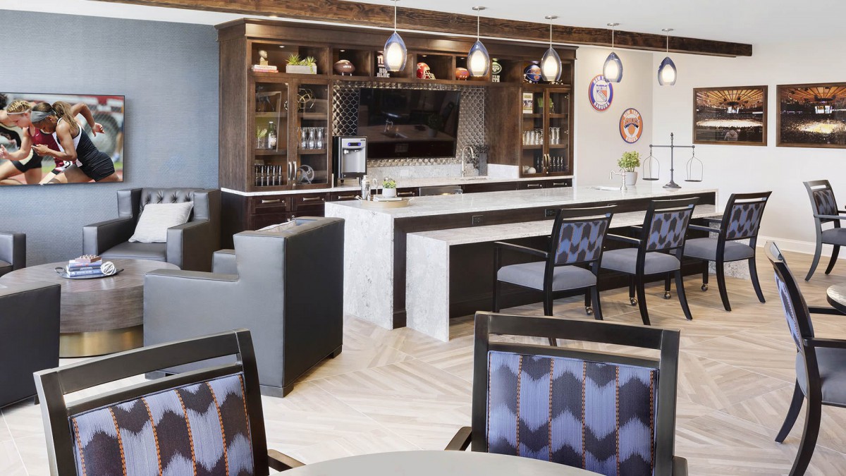 A modern lounge area featuring a stylish bar and comfortable seating.