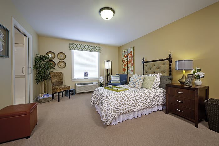 A cozy bedroom with elegant decor and a comfortable bed.