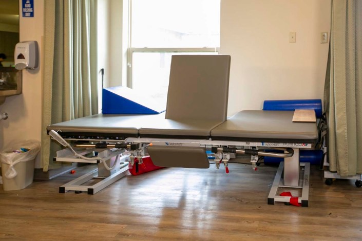 A physical therapy treatment table in a clinic setting.