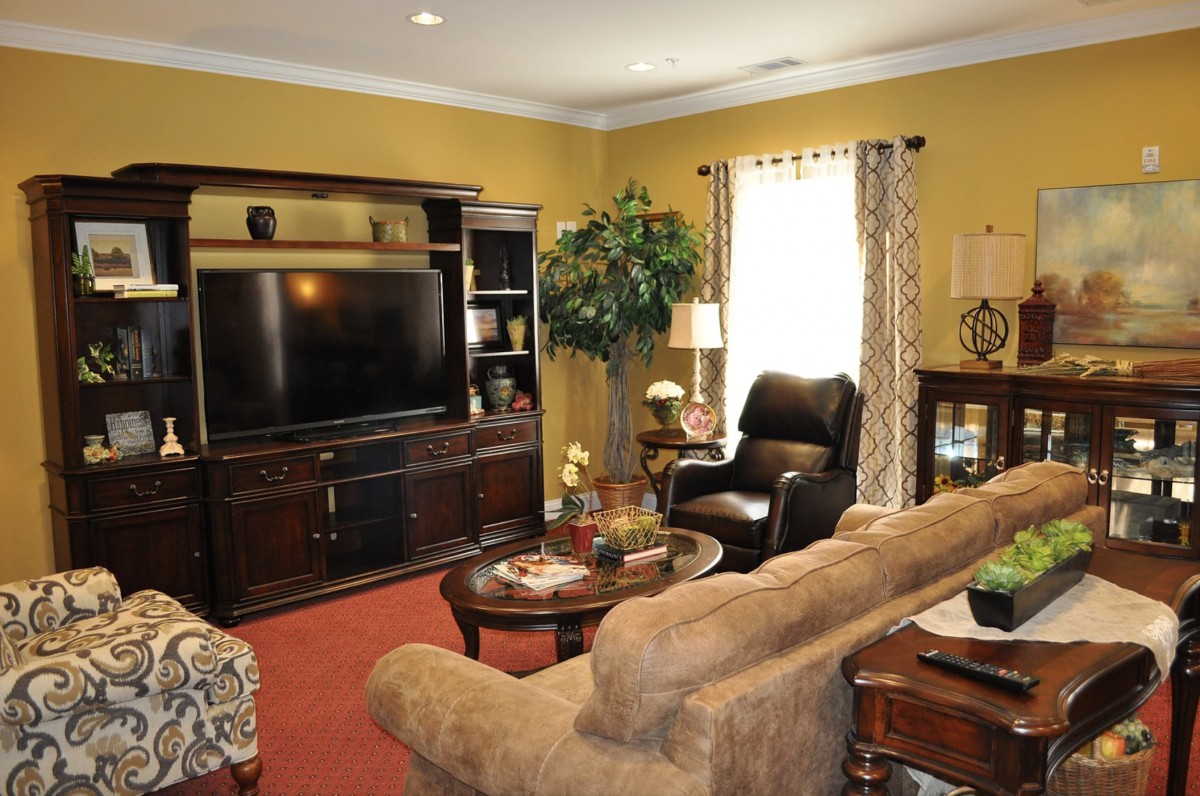 A cozy living room featuring a large television, comfortable seating, and stylish decor.