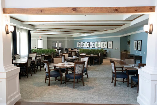 A spacious and elegantly designed dining area with ample seating and decorative elements.