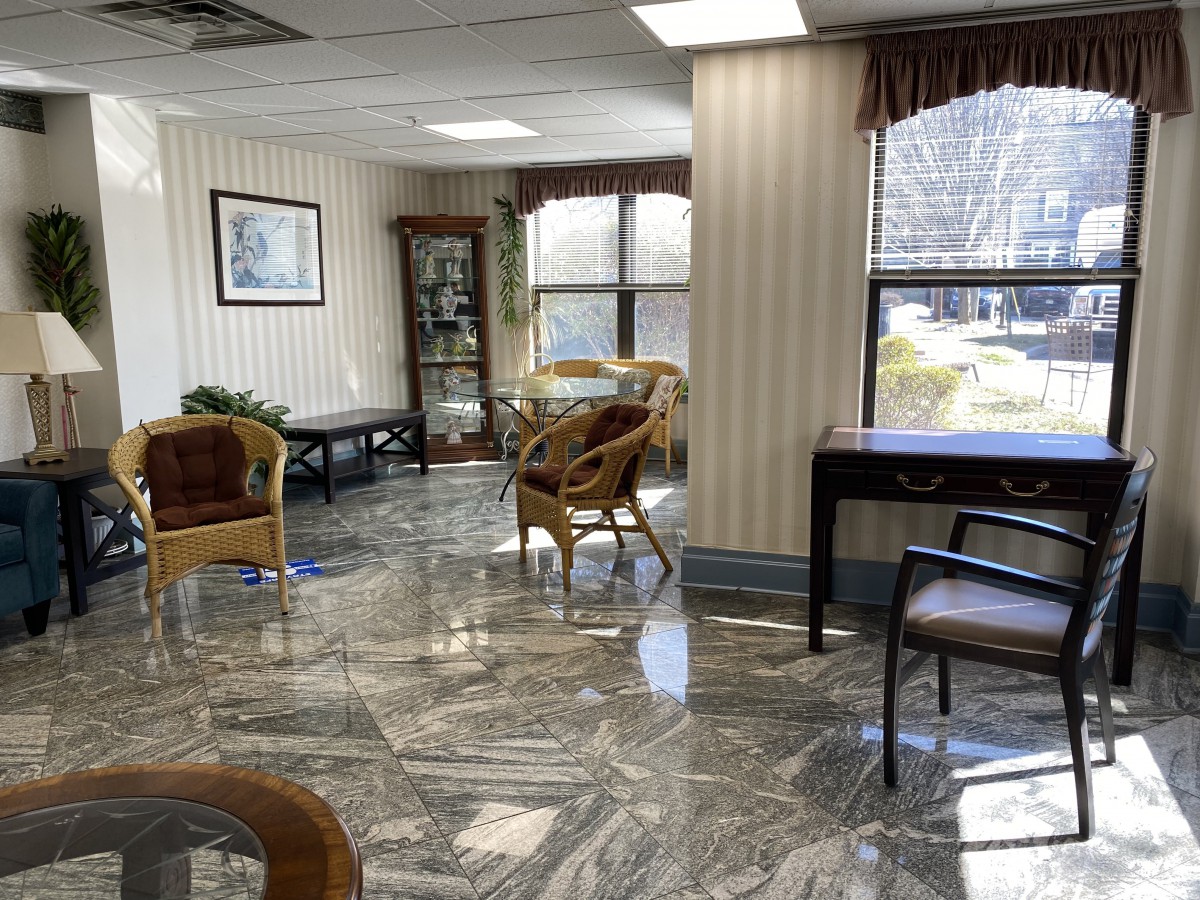 A well-lit waiting room with comfortable seating and large windows.
