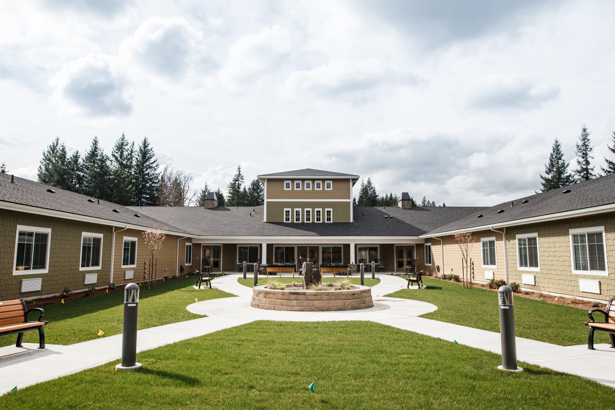 A modern building with a central courtyard and well-maintained garden.
