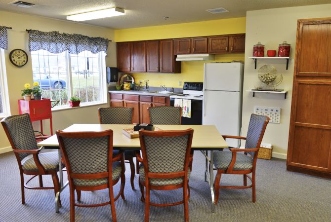 A cozy kitchen and dining area with a table, chairs, and basic appliances.