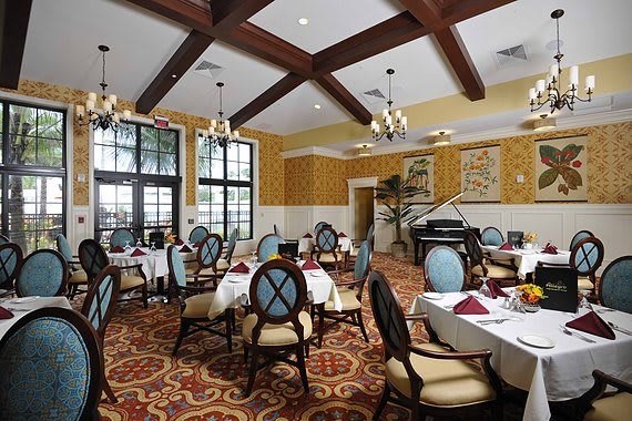An elegant restaurant dining room with neatly arranged tables and classic decor.