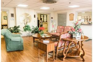 A cozy lobby with comfortable seating and indoor plants, featuring a warm and inviting atmosphere.