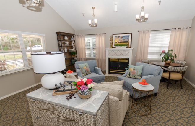 A cozy living room with stylish furniture and a warm fireplace.