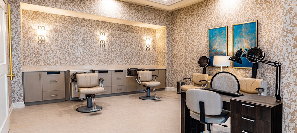 A modern salon interior featuring stylish chairs and elegant decor.