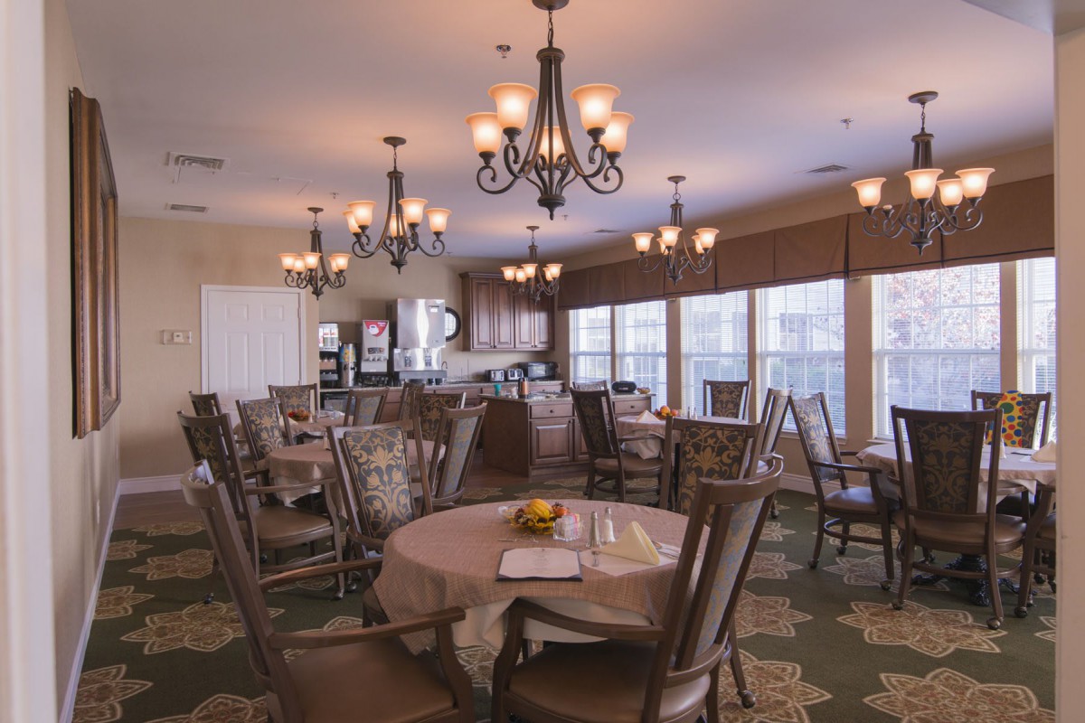 A serene dining area with elegant chandeliers and comfortable seating.