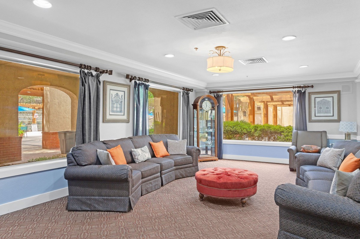 A cozy living room with comfortable seating and large windows.