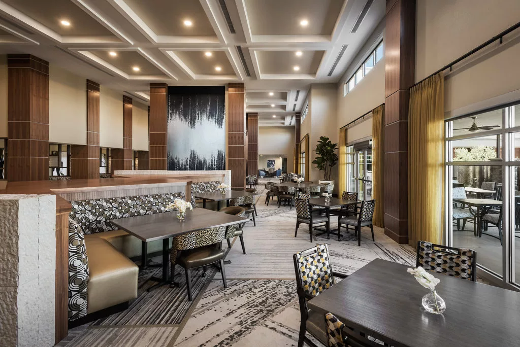 A modern dining area with elegant interior design and ample seating.