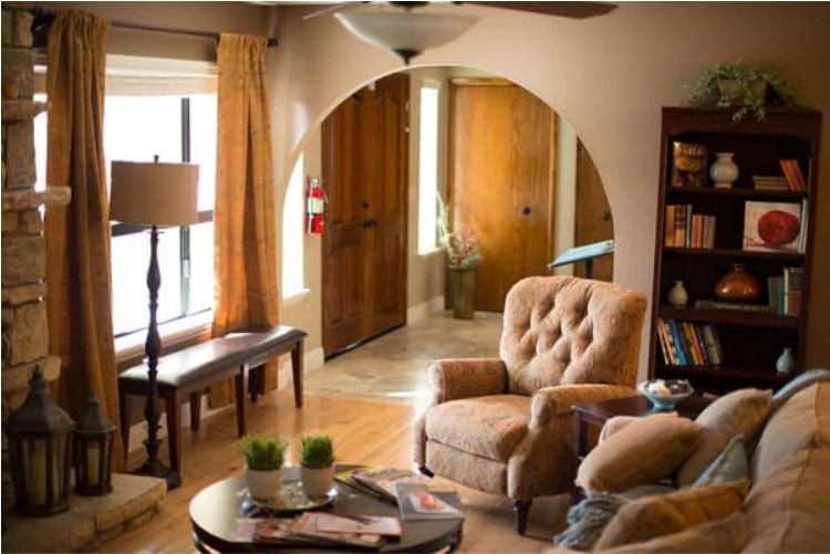 A cozy living room with comfortable armchairs and warm natural lighting.