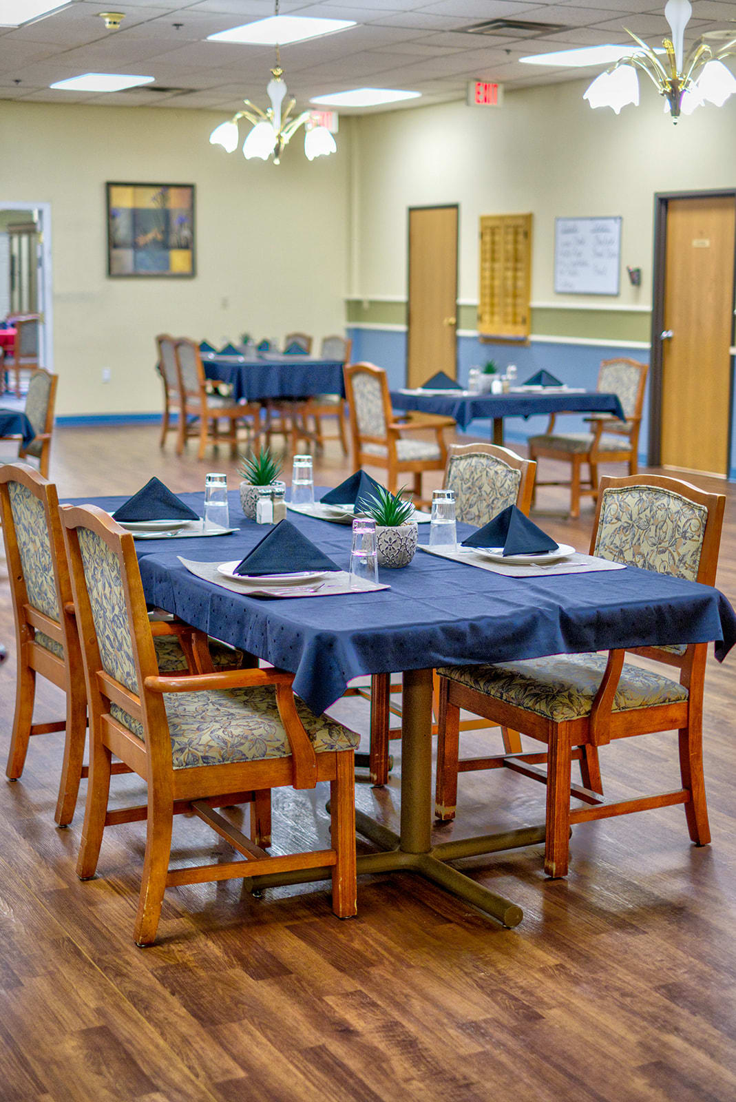 A well-arranged dining area with neatly set tables and chairs.