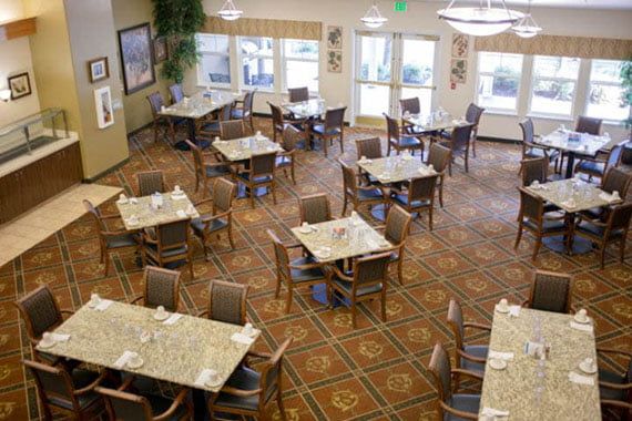 An empty dining area with neatly arranged tables and chairs.