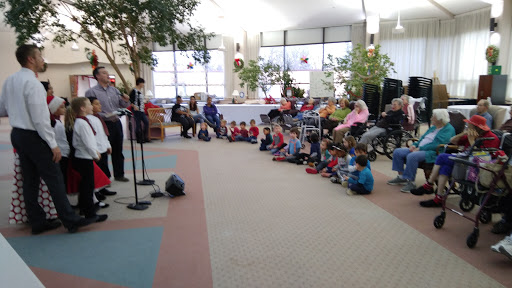 A lively performance engaging children in a cozy indoor setting.