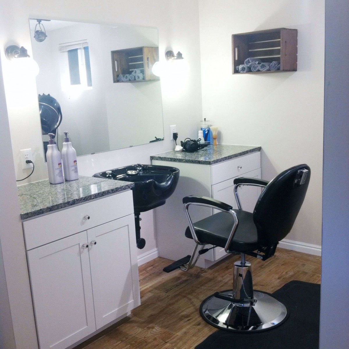 A modern hair salon setup with a barber chair and sink.