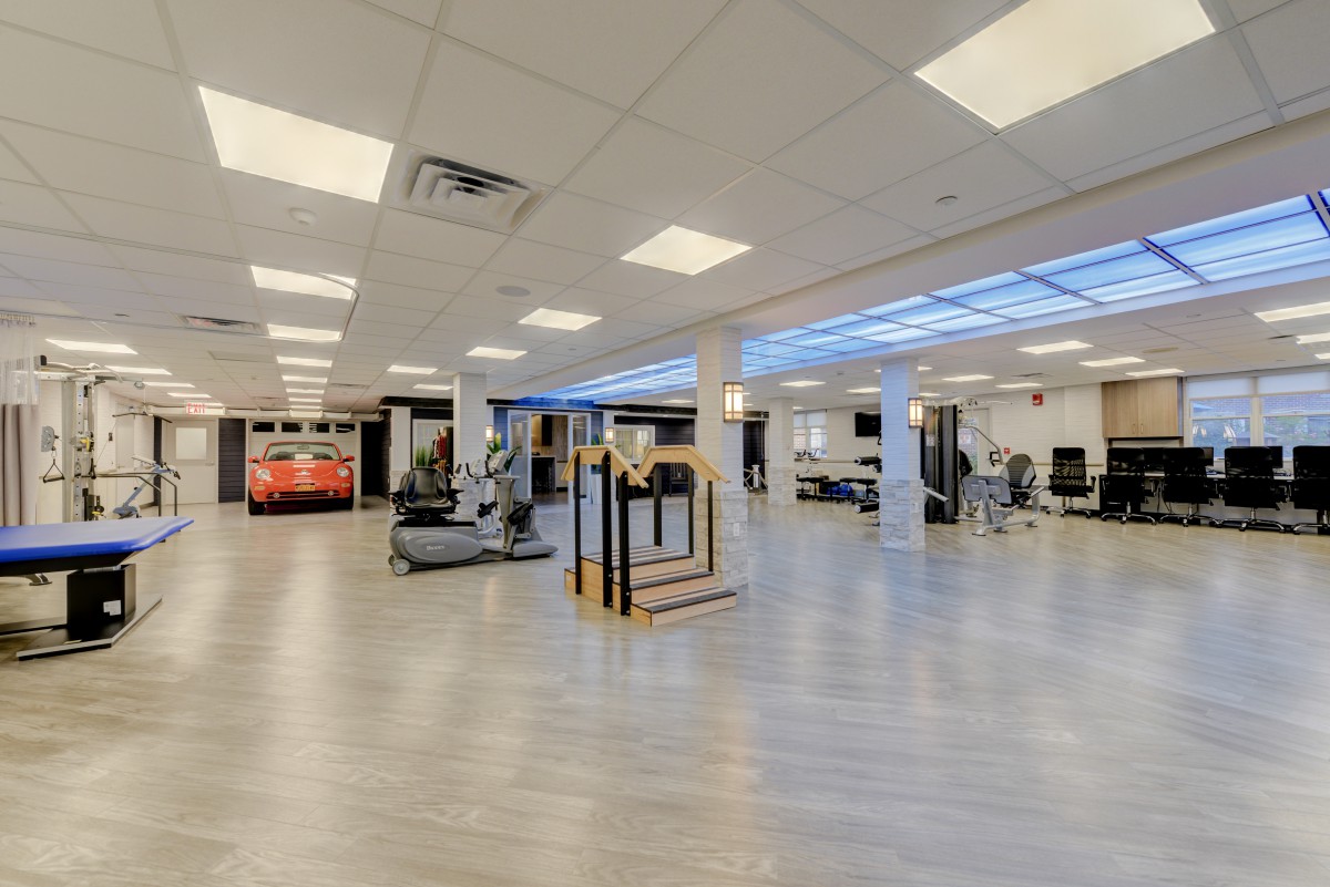 A spacious and modern gym with a variety of exercise equipment.