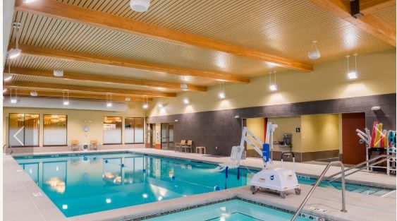 A spacious indoor swimming pool area designed for relaxation and leisure activities.