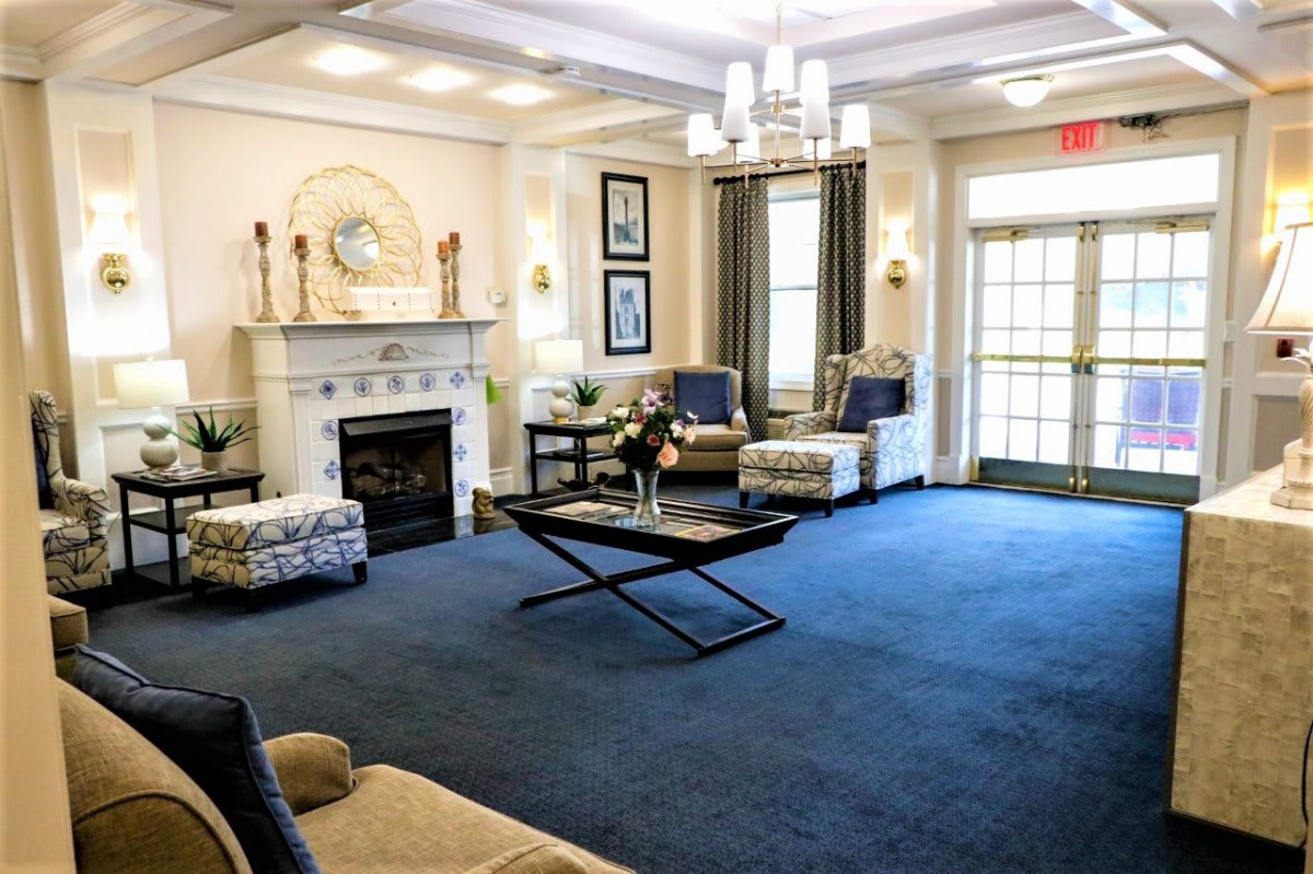 A modern living room with elegant furnishings and a cozy fireplace.