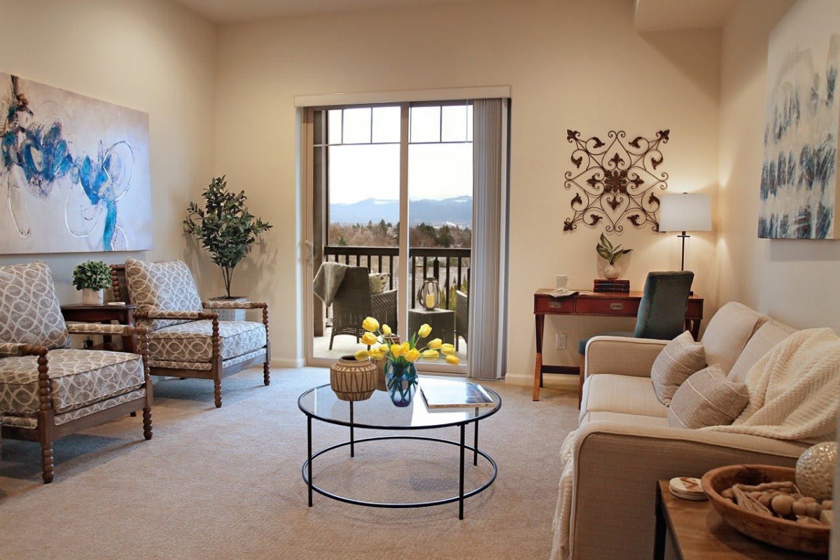 A cozy living room with modern decor and a balcony view.