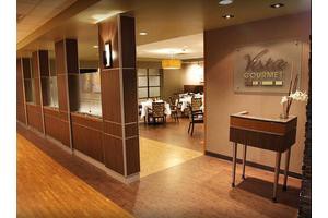 A modern restaurant interior with a welcoming entrance and elegant dining area.