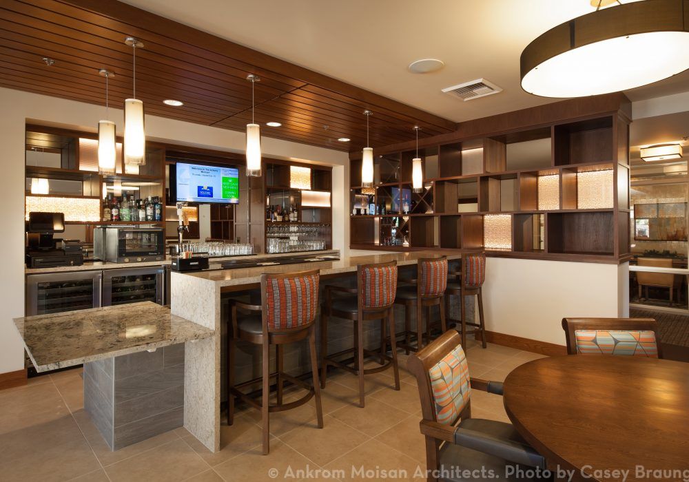 A modern bar area with comfortable seating and stylish lighting.