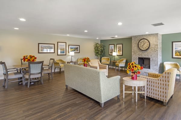 A cozy living room with modern furniture and floral decor.