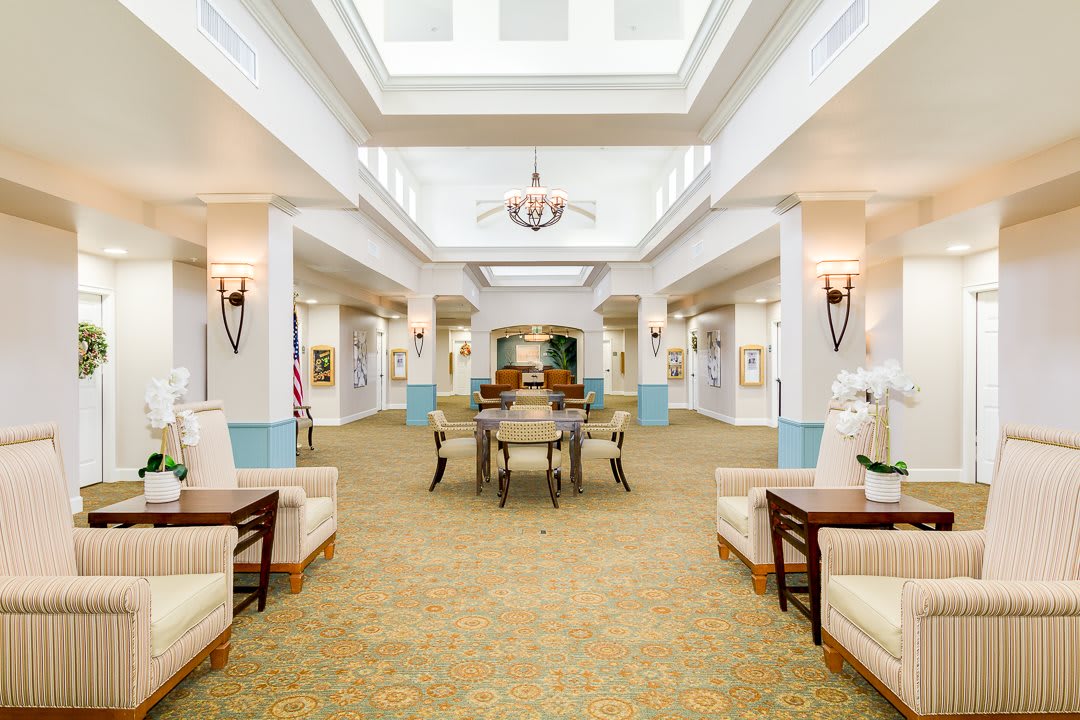 A well-lit lobby area with comfortable seating and elegant decor.
