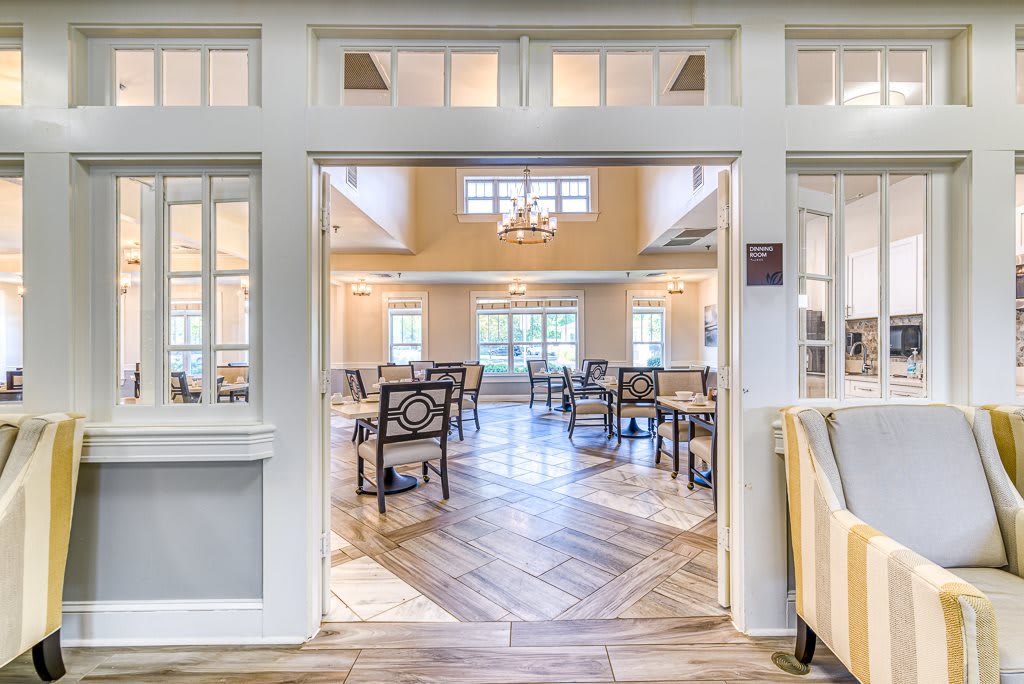 A bright and spacious dining area with elegant furniture and ample natural light.
