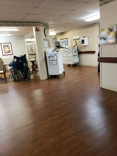 A view of the interior of a healthcare facility, featuring a wheelchair and medical equipment.