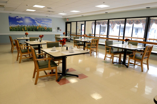 A spacious and well-lit dining area featuring neatly arranged tables and chairs, ready for patrons.