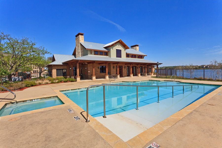 A luxurious house with a spacious outdoor pool and patio area.