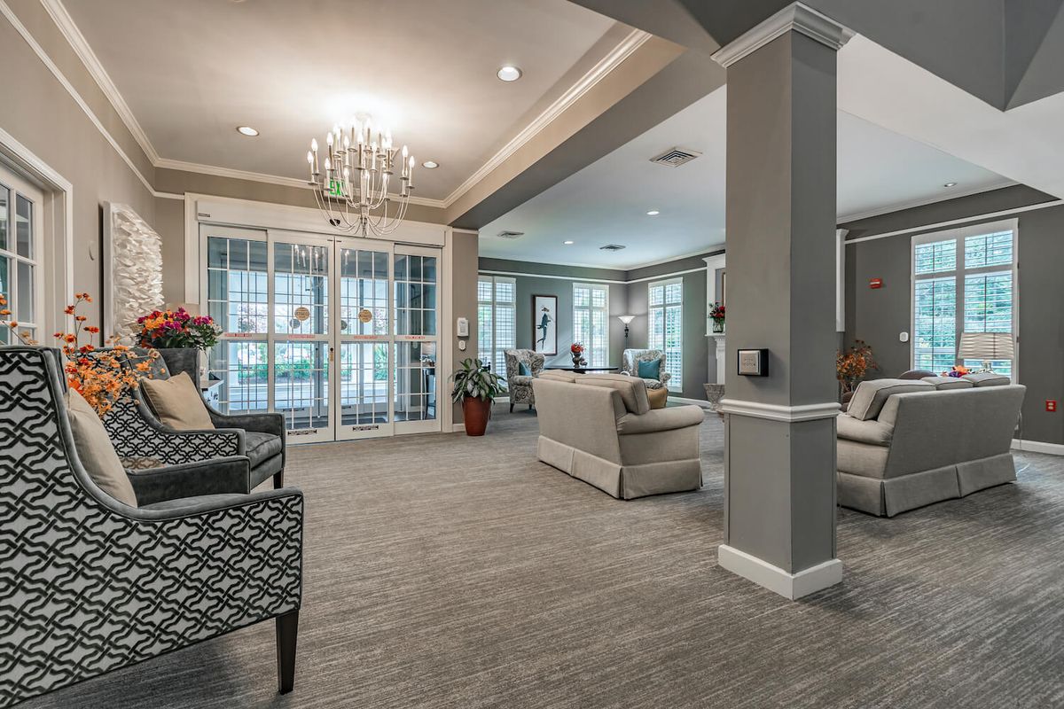 A cozy and elegantly decorated living room with soft lighting and comfortable seating.