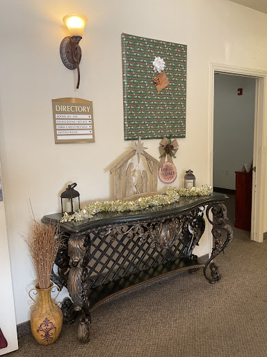 A beautifully styled entryway featuring an ornate console table and decorative wall art.