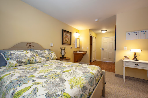 A cozy and inviting bedroom featuring floral bedding and warm lighting.
