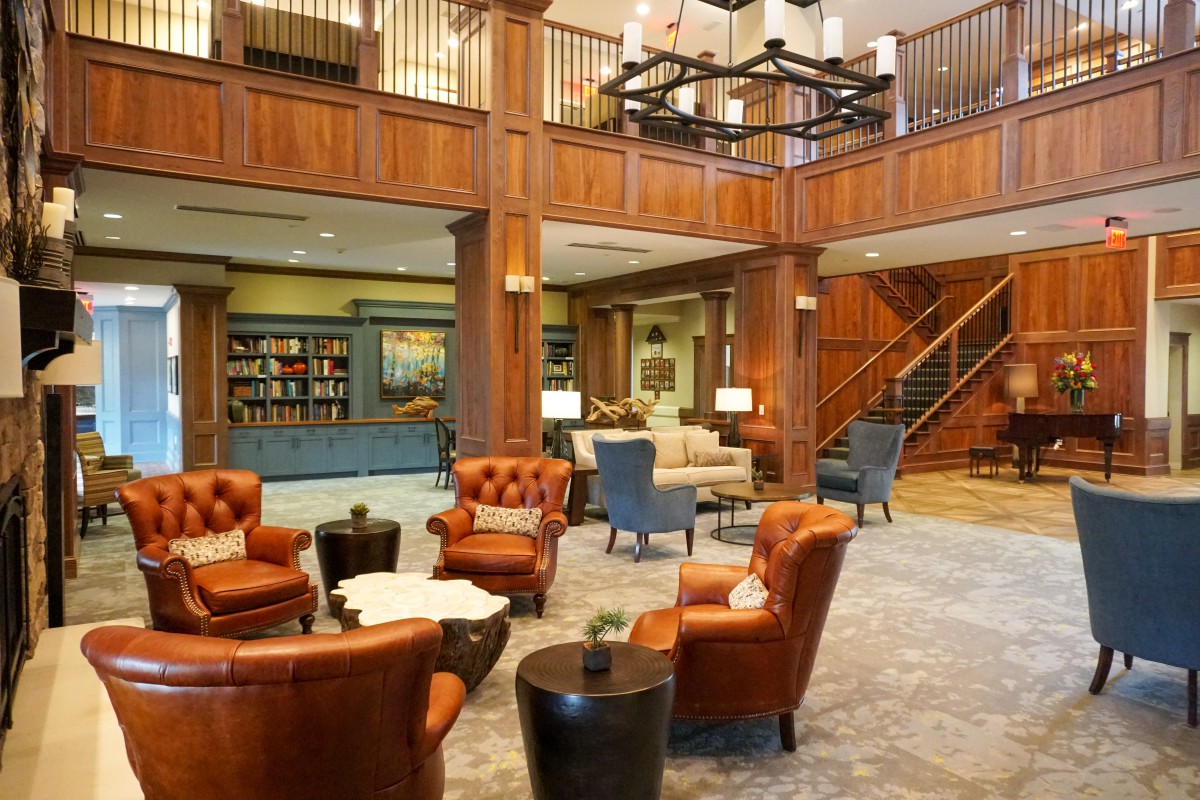 A luxurious hotel lobby with comfortable seating and elegant wood paneling.