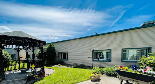 A peaceful residential exterior featuring a well-maintained garden and clear blue skies.