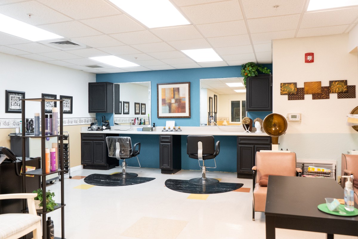 A modern hair salon with stylish chairs and mirrors.