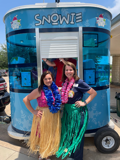 Enjoying a sunny day with delicious snow cones at the food truck!