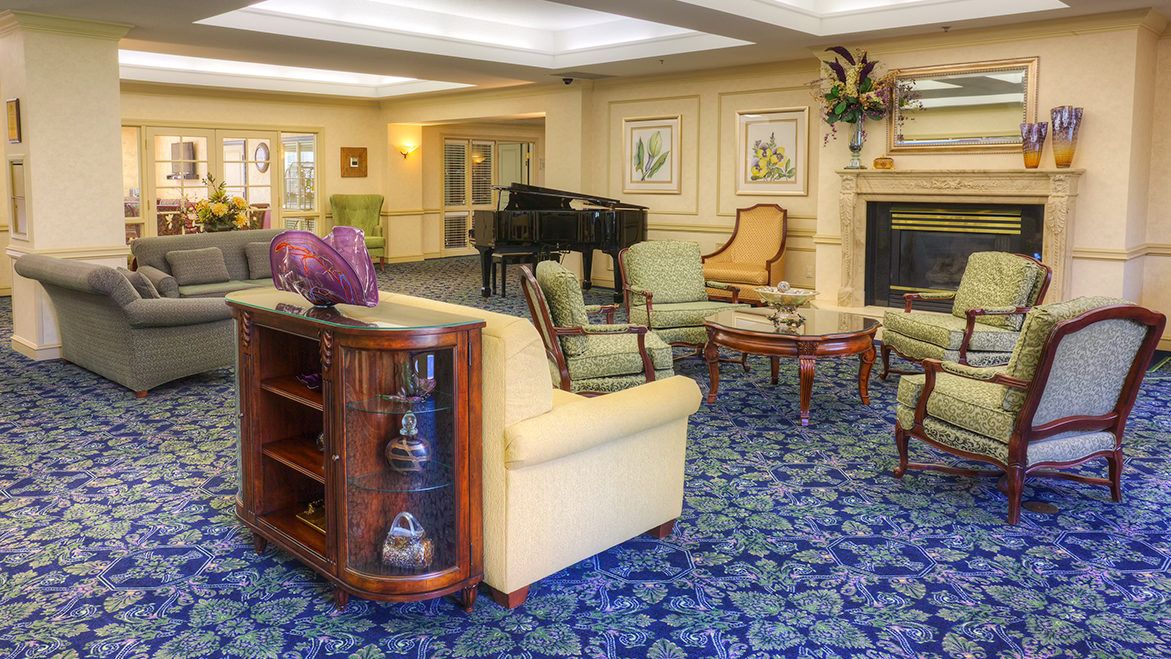 A cozy living room with elegant furniture and a grand piano.