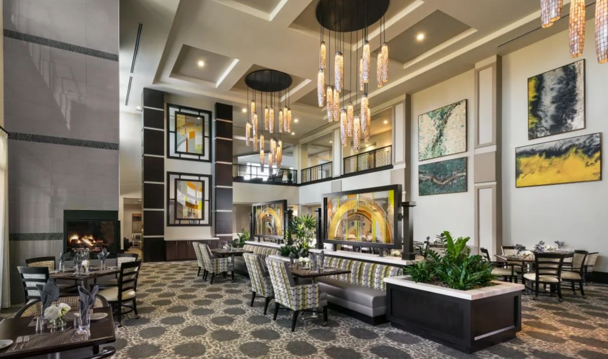 A luxurious lobby with modern decor, featuring elegant chandeliers and comfortable seating.