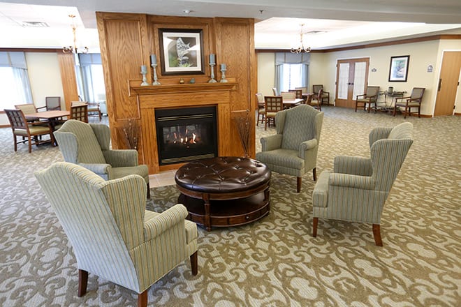 A cozy living room with a fireplace and comfortable seating arrangements.