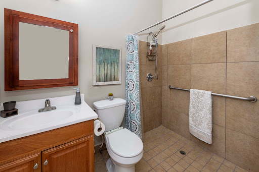 A compact and aesthetically pleasing bathroom featuring a shower, toilet, and vanity sink.