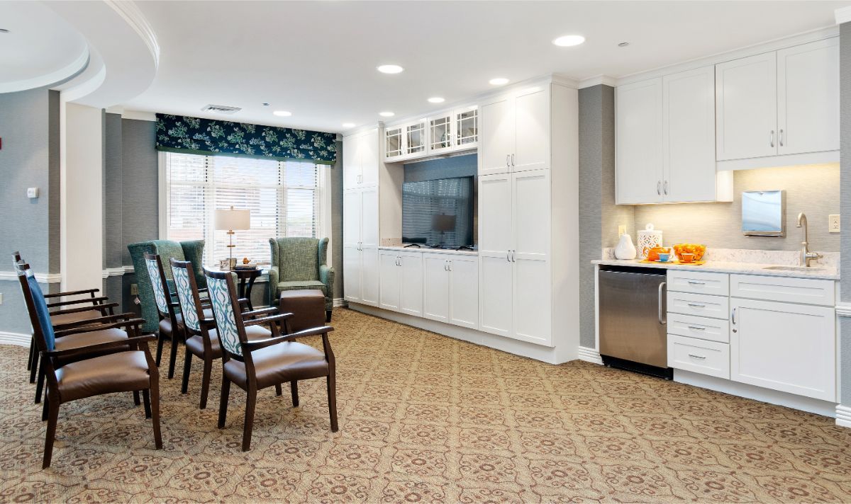 A modern living room with comfortable seating, a large TV, and elegant decor.