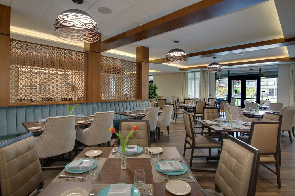 A modern restaurant interior with neatly arranged tables and comfortable seating.