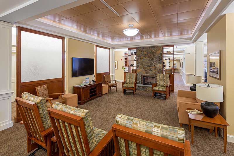 A cozy living room with a fireplace and comfortable seating arrangement.