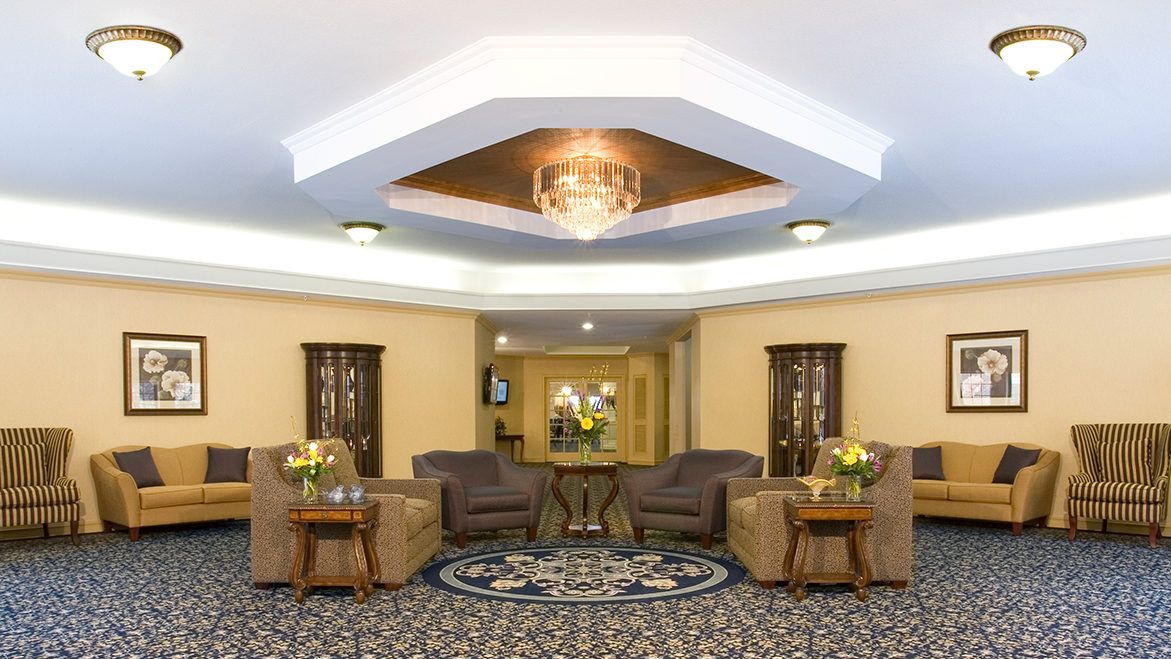 A well-decorated hotel lobby featuring comfortable seating and a chandelier.