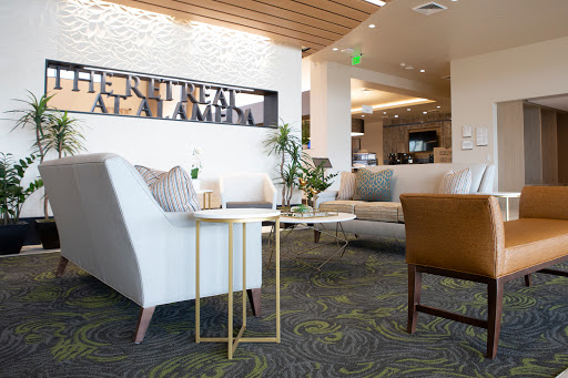A stylish and modern lobby seating area featuring comfortable furniture, decorative plants, and an inviting atmosphere.